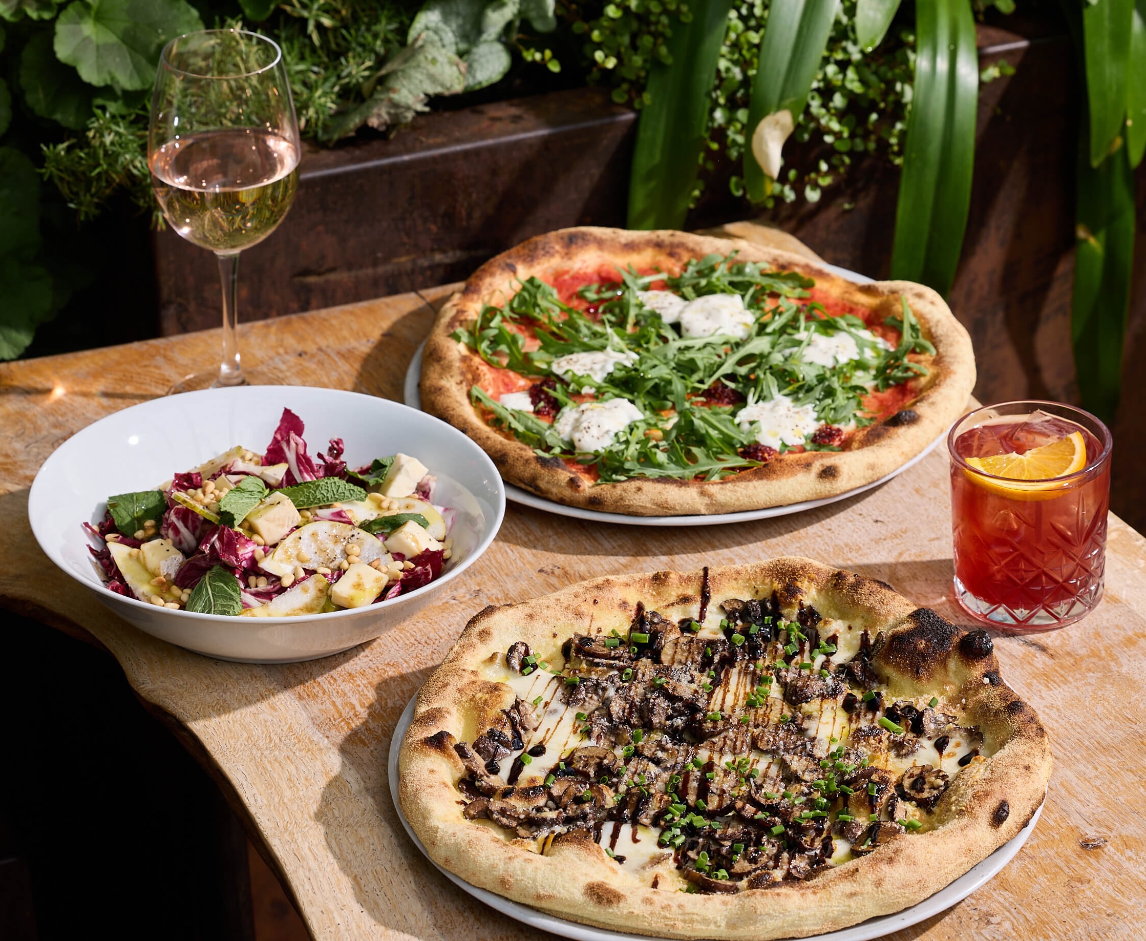 Sharing wood woodfired pizzas and cocktails during dinner service